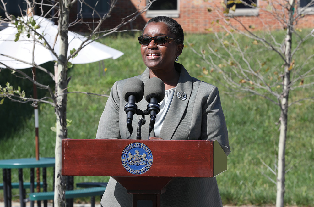 Pennsylvania’s acting Secretary of Health & Physician General, Denise Johnson, MD speaks outdoors in front of a podium at the Ann B. Barshinger Cancer Institute.
